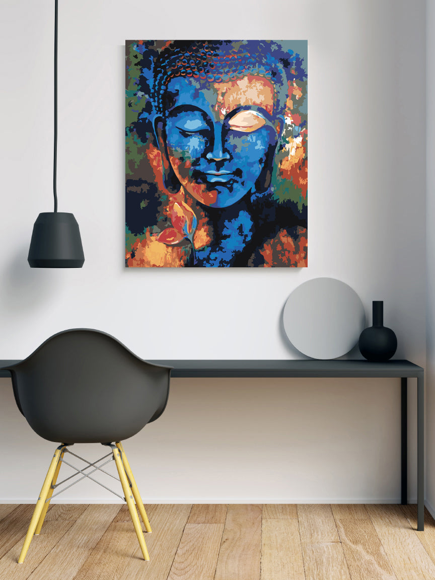 a painting of a buddha face on a white wall